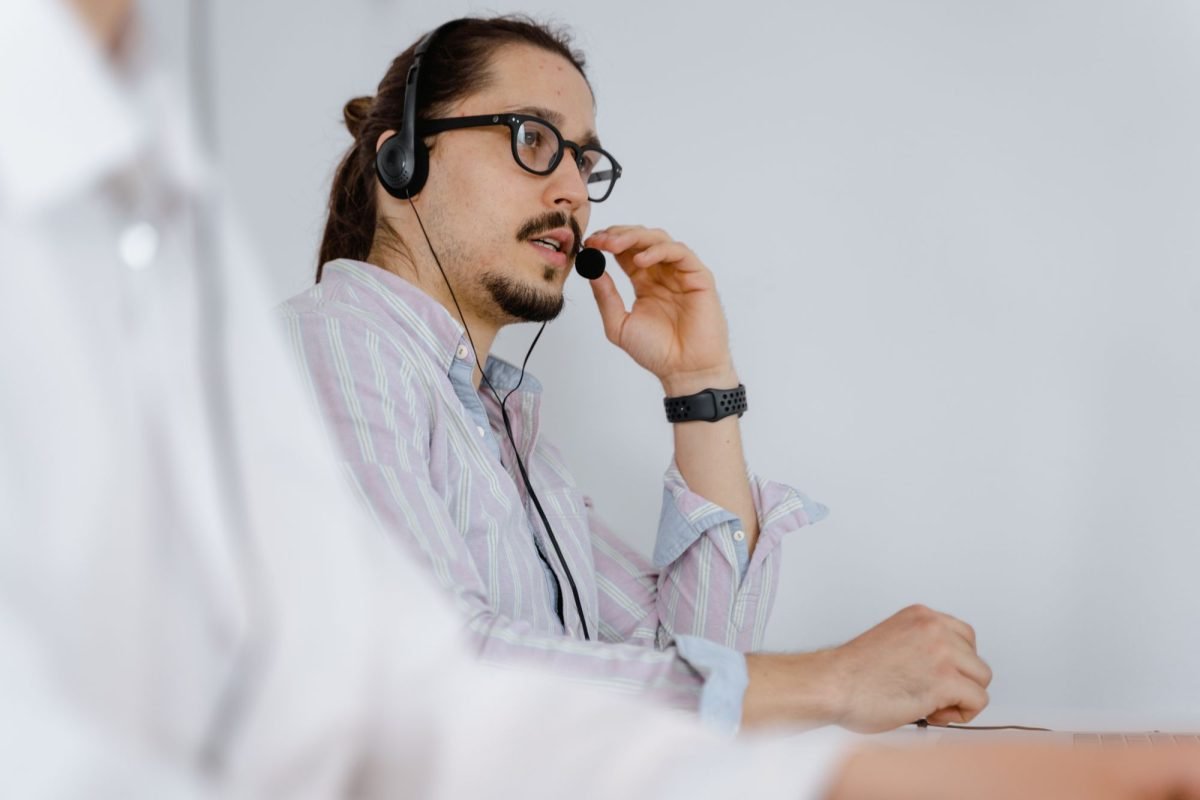A customer service agent speaking on a phone headset