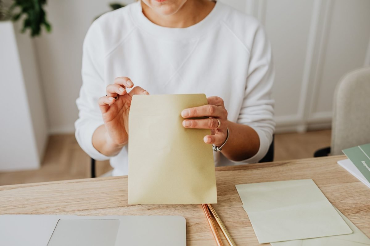 A person holding a brown envelope