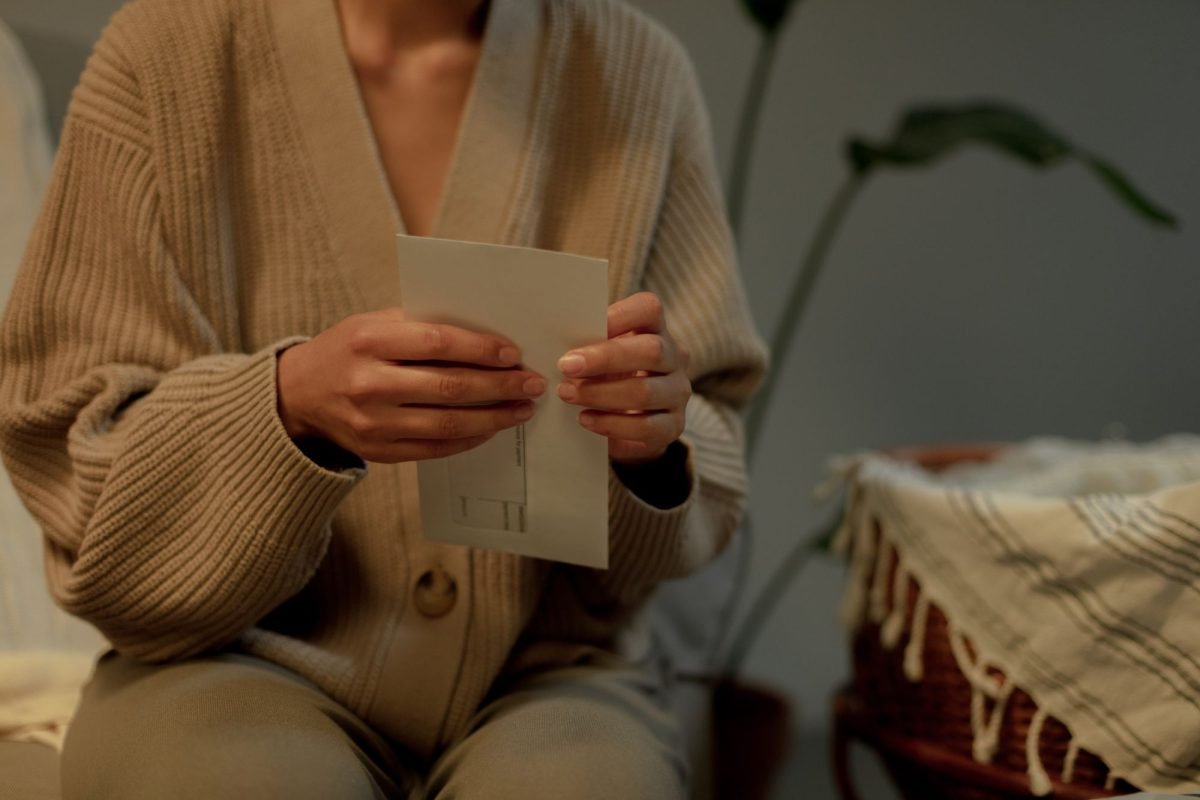 A person holding a letter indoors