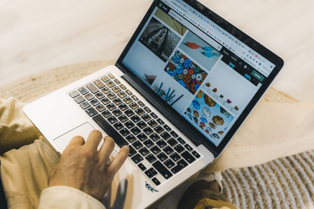 A person using a silver laptop