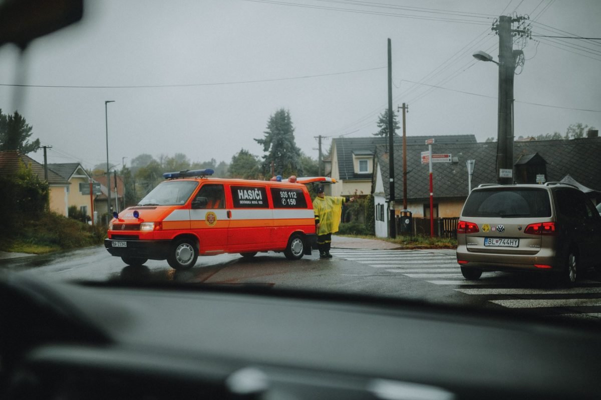 A fire department vehicle blocking a street intersection in wet weather