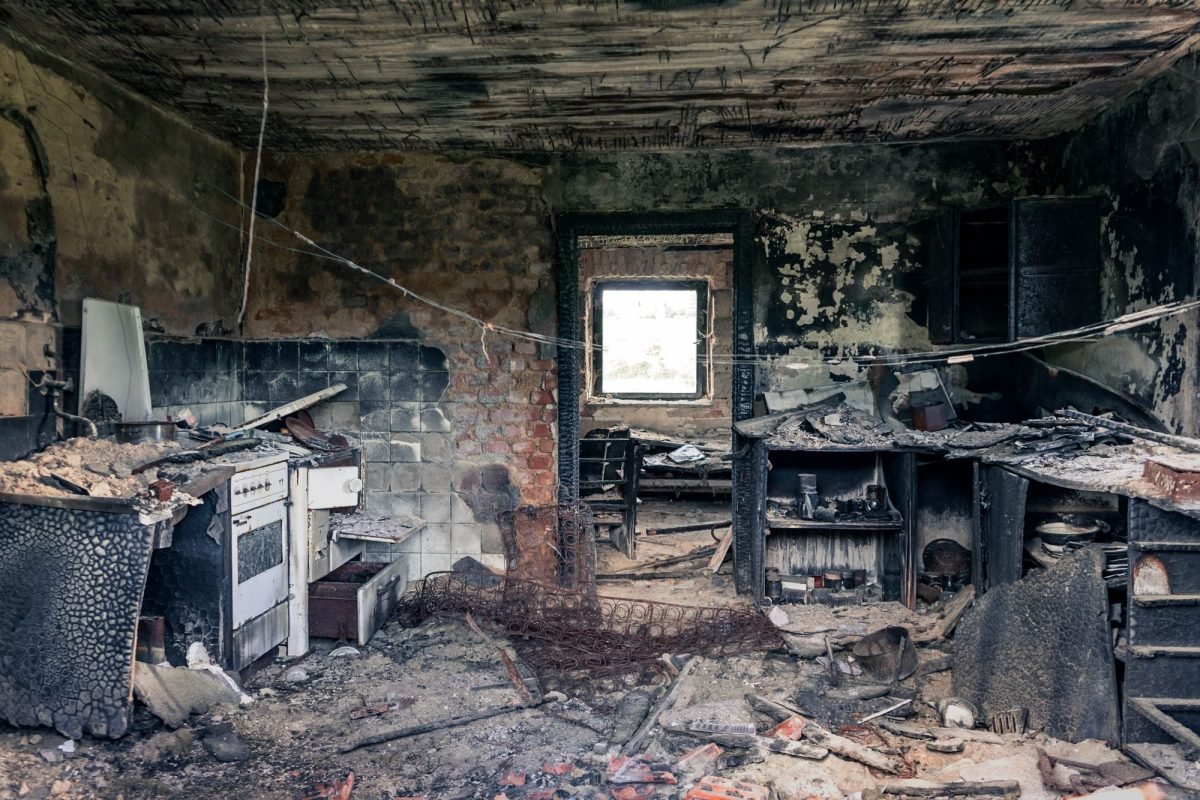 A fire-damaged kitchen in an abandoned building