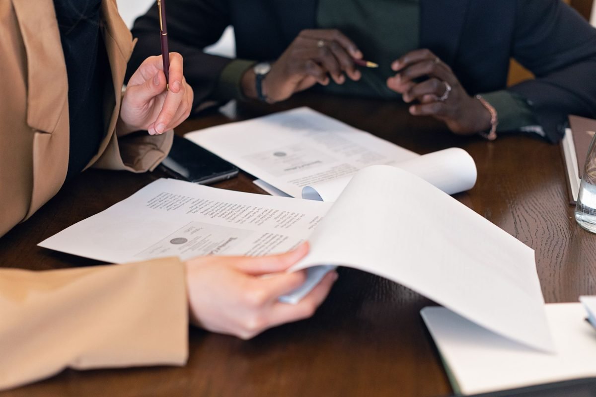 Professionals reviewing documents together during a meeting in an office