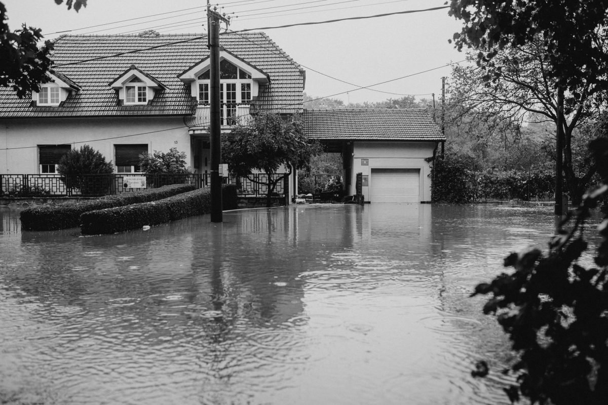 A suburban house surrounded by floodwater