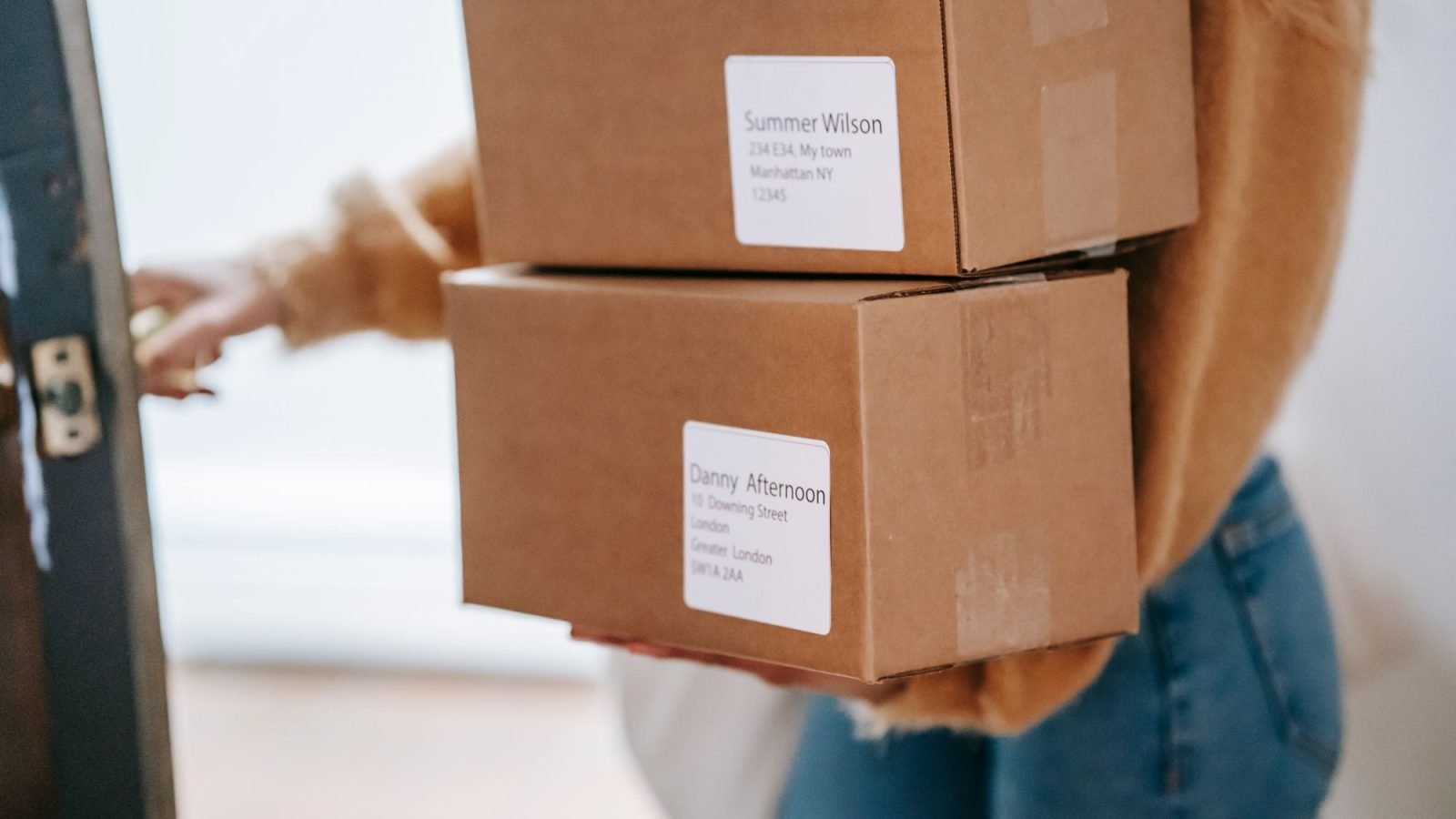 A woman carrying parcels and entering a post office
