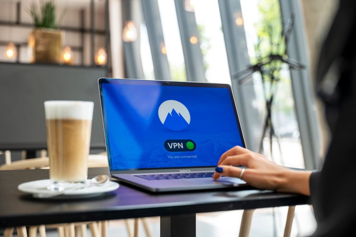 A person using a laptop in a cafe