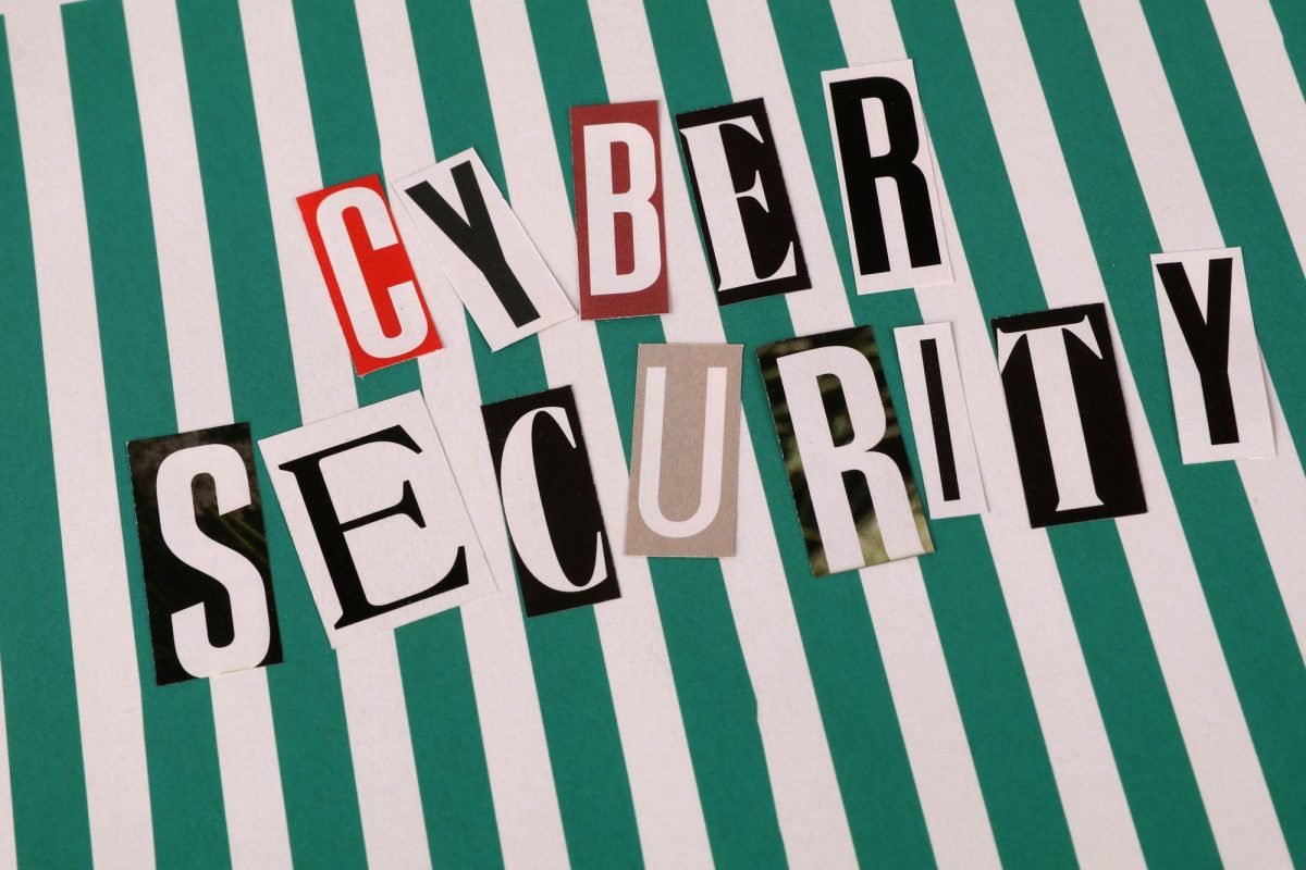 Cyber security concept shown as a text collage on a striped background