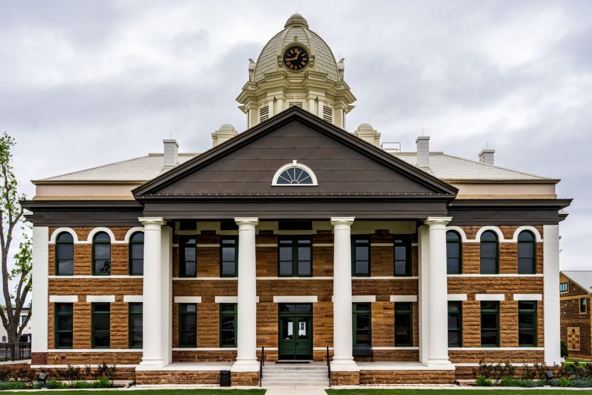 The historic Mason County Courthouse in Texas against a cloudy sky