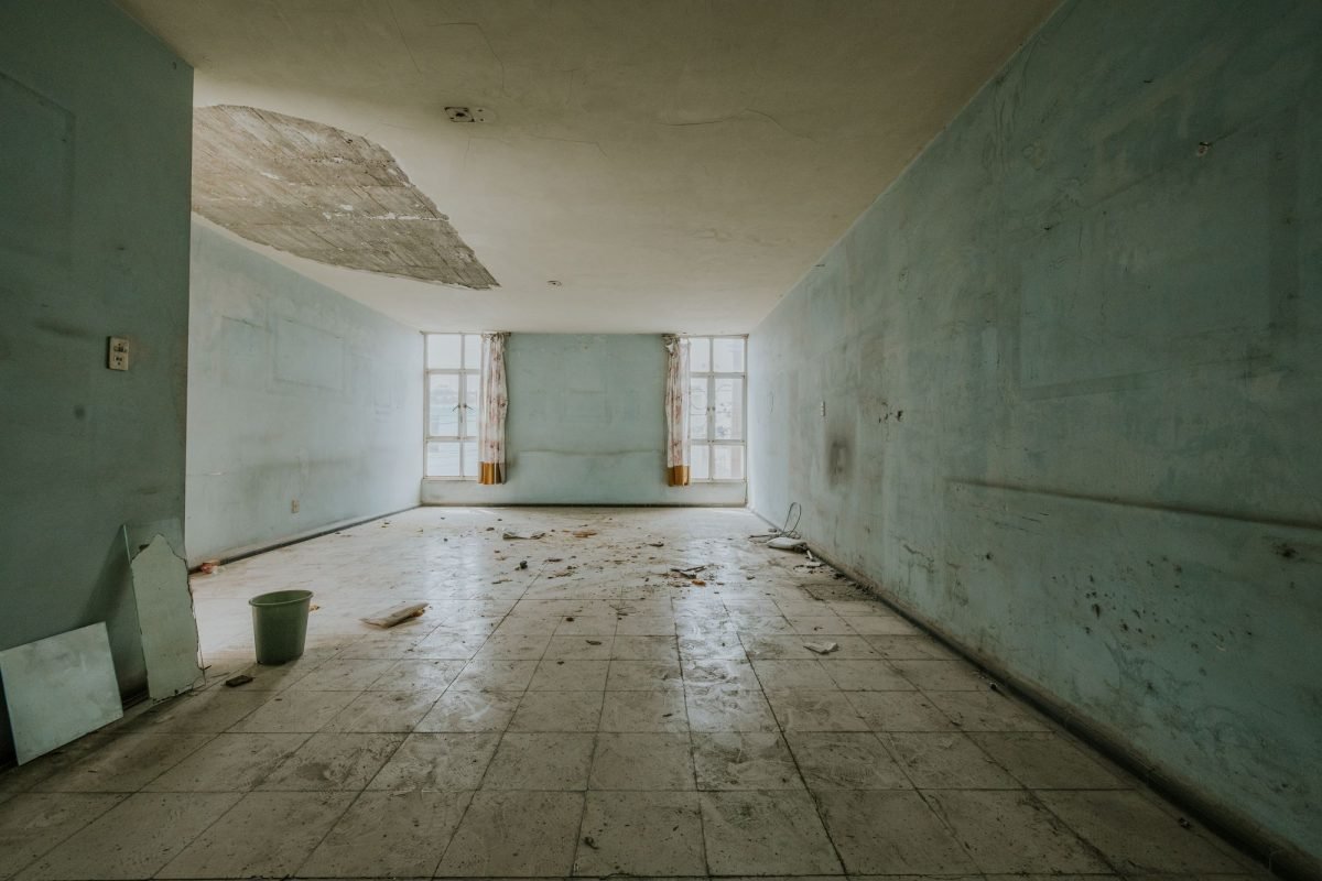 Damaged walls with peeling paint in an abandoned room
