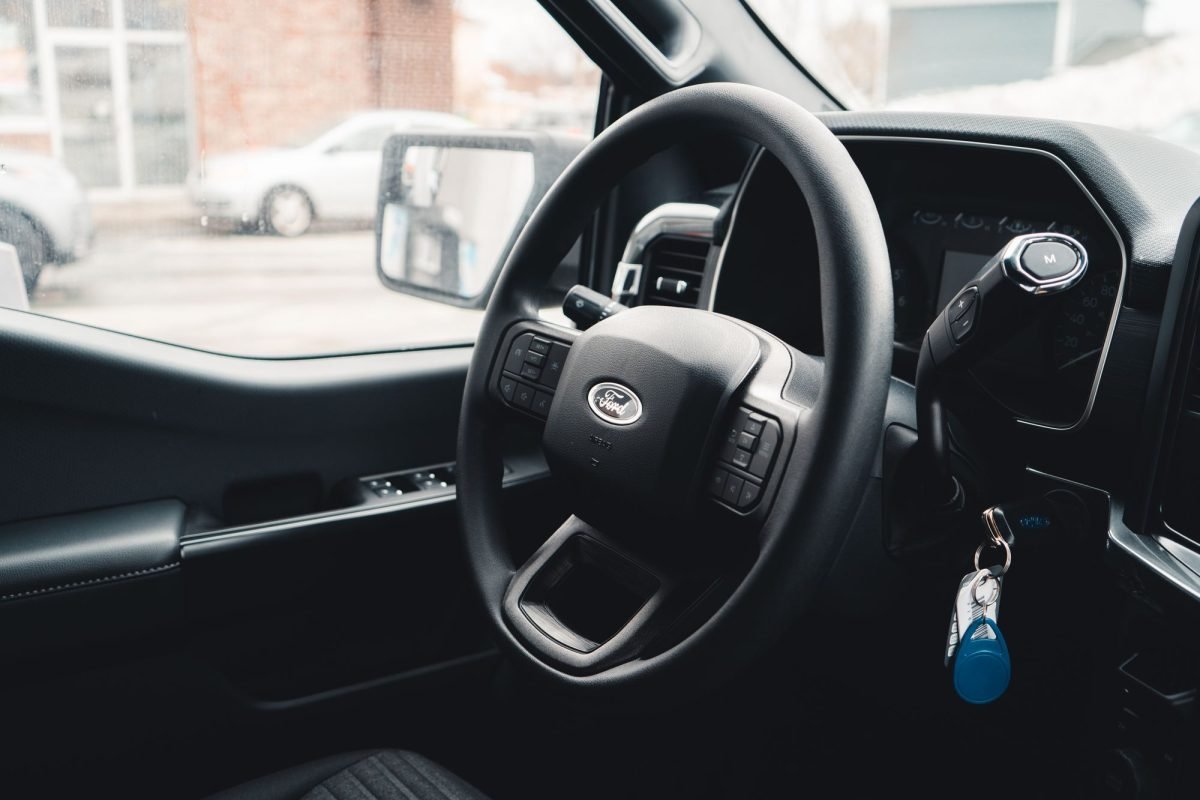 Interior of a Ford vehicle showing the steering wheel, dashboard and keys