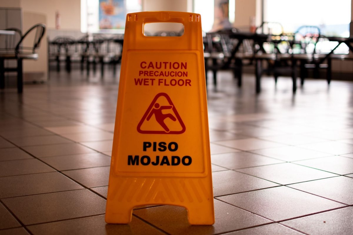 A yellow wet floor sign in a restaurant