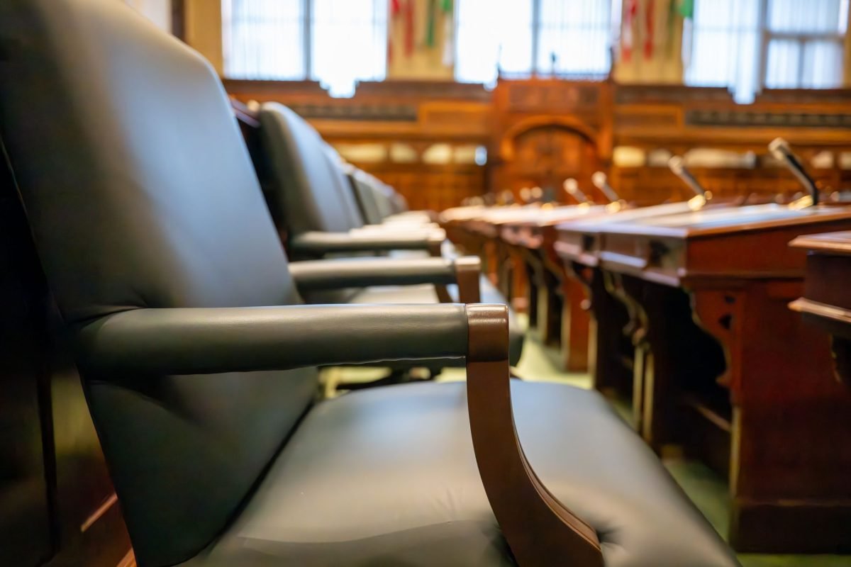 Elegant courtroom seating with leather chairs and wooden desks