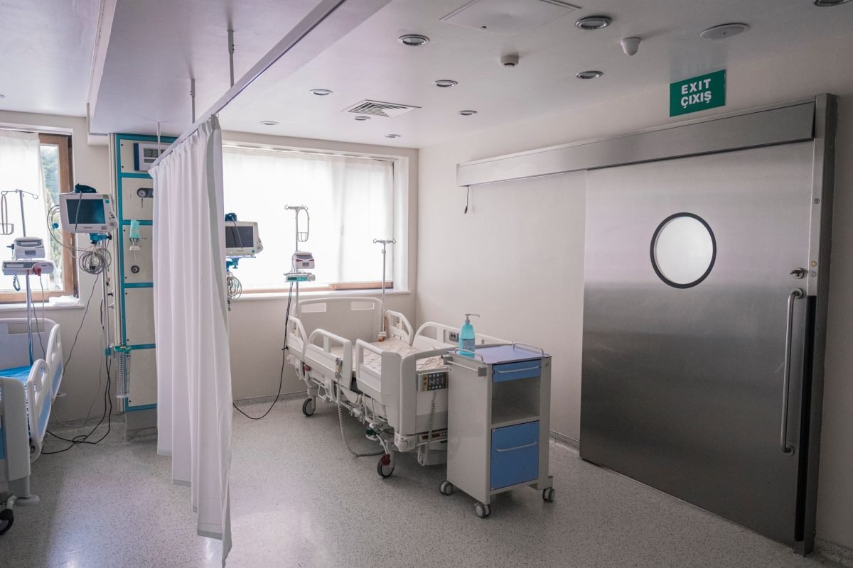 A hospital room with medical beds and equipment