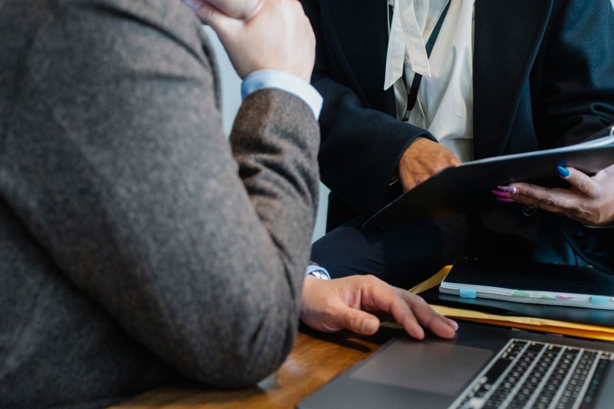 An employee pointing at a document while working with a colleague